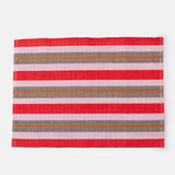 A handwoven placemat with red, pink, and brown stripes, placed on a white background.