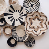Collection of woven baskets with various patterns on a light background