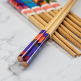 Close up detail of a set of chopsticks with a colourful geometric design