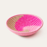 Pink woven bowl on a white background