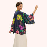 Woman wearing a colorful floral blouse on a white background