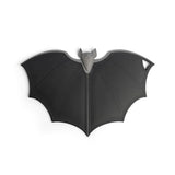 Black bat-shaped cutting board on a white background