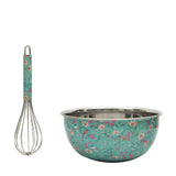 Floral-patterned mixing bowl and whisk on a white background