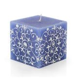 Blue square candle with white floral patterns on a white background