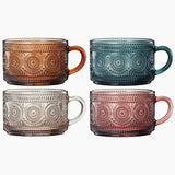 Four patterned mugs in different colors on a white background