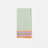 A cloth napkin in a striped pattern of green, orange and purple.