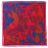 Colorful abstract patterned fabric with red, blue, and pink colors on a white background