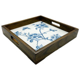 Wood tray with a blue and white ceramic insert in floral pattern.