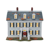 Model of a two-story house with decorative elements on a white background