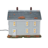 Model of a house with lit windows on a white background