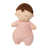Plush toy baby doll with brown hair and pink outfit on a white background