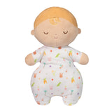 Plush toy baby doll with blonde hair and a patterned outfit on a white background