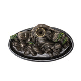 Decorative mountain-shaped incense burner on a white background