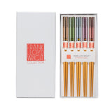Set of chopsticks with colored handles in a Frank Lloyd Wright Collection box.