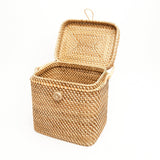 Woven picnic basket with a lid on a white background