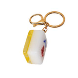 Keychain with a yellow and white object on a white background