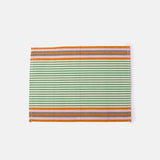 A rectangular placemat with a striped pattern in green and orange tones.