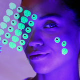Person with UV-reactive stickers on face and body