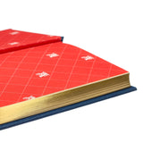 Red book with grid pattern and gold spine on a white background