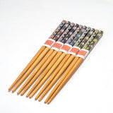 Set of wooden chopsticks with patterned wraps on a white background