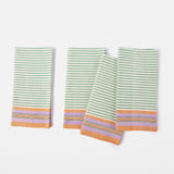 Set of four cloth napkins in a striped pattern of green, orange and purple.