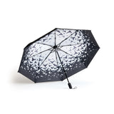 Interior of a black umbrella with flying bats pattern on a white background
