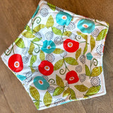 Floral patterned fabric square on a wooden surface