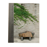 A hardcover book titled 'The Nagoldi Museum | A Portrait' by Tina Barny & Stephen Shore, published by Phaidon, lying flat on a white surface. The cover features a photograph of green ivy climbing a gray brick wall with a stone bench in the foreground.