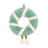 Green and white plush wreath toy covered in pinecone with a smiling face and feet.