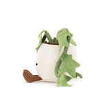 Plush toy plant with green leaves and a white pot on a white background