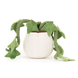Plush toy resembling a potted plant with green leaves on a white background