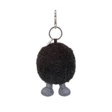 Black fuzzy keychain with legs on a white background