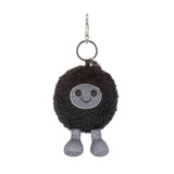 Black plush keychain with a smiling face on a white background