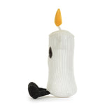A white ribbed plush candle toy with a yellow flame on top, small black embroidered eyes, and a black textured foot, photographed on a clean white background.