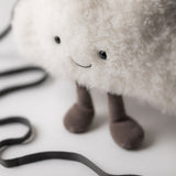 White plush cloud toy with a black strap on a white background