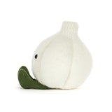 A knitted garlic plush toy in off-white with olive green feet and a simple embroidered smiley face, photographed on a clean white background.
