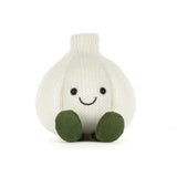 A knitted garlic character plush toy with a smiling face and olive green feet, photographed against a seamless white background.