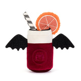 A plush toy shaped like a vampire drink in a glass, with a deep red body, white rim, black wings, black feet, a striped straw, and an orange slice decoration on a white background.