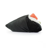 Stuffed toy resembling a sushi roll with black exterior, orange and green fillings on a white background