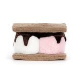 Toy resembling a s'more with brown, white, and pink layers on a white background