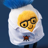 Plush toy with a face design wearing a white shirt on a dark blue background