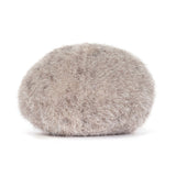 Plush toy resembling a round small stone with a smiling face on a white background