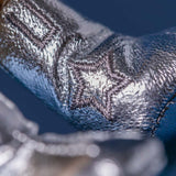 Close-up of a textured metallic surface with a star design.