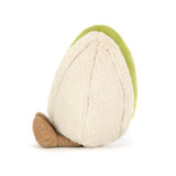 Plush toy shaped like a pistachio with a smiling face on a white background