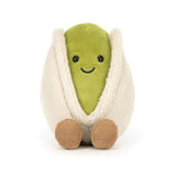 Plush toy shaped like a pistachio with a smiling face on a white background