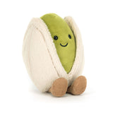 Plush toy in the shape of a pistachio with a smiling face on a white background