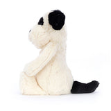 Plush toy dog with black nose on a white background