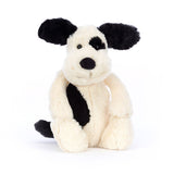 Black and white plush dog on a white background