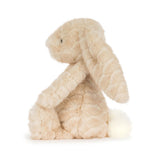 A plush stuffed bunny toy in a soft cream-beige color, sitting upright against a clean white background.