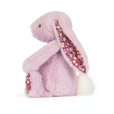 Pale purple plush bunny with floral ears and feet on a white background